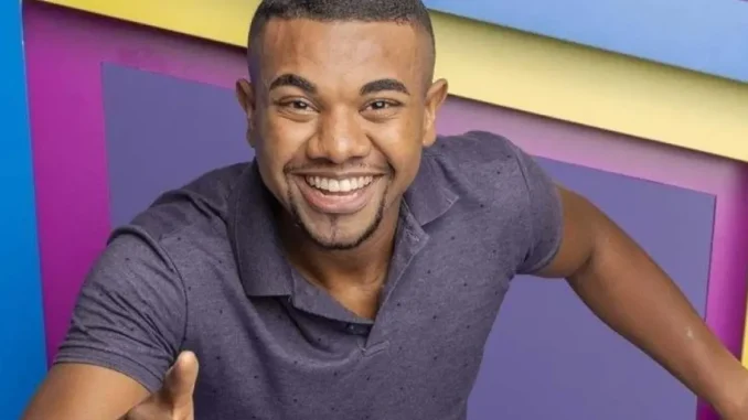 Foto de Davi Brito, vencedor do BBB 24, com sorriso contagiante e polegar para cima em fundo colorido